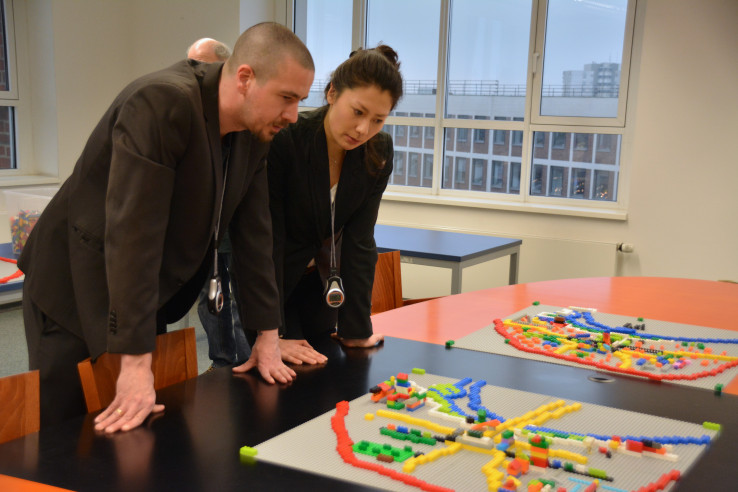 Workshop-Leiter Elisa Hofmann und Heiner Remmert betrachten die ersten Lego-Entwürfe; Foto: Vera Lisakowski